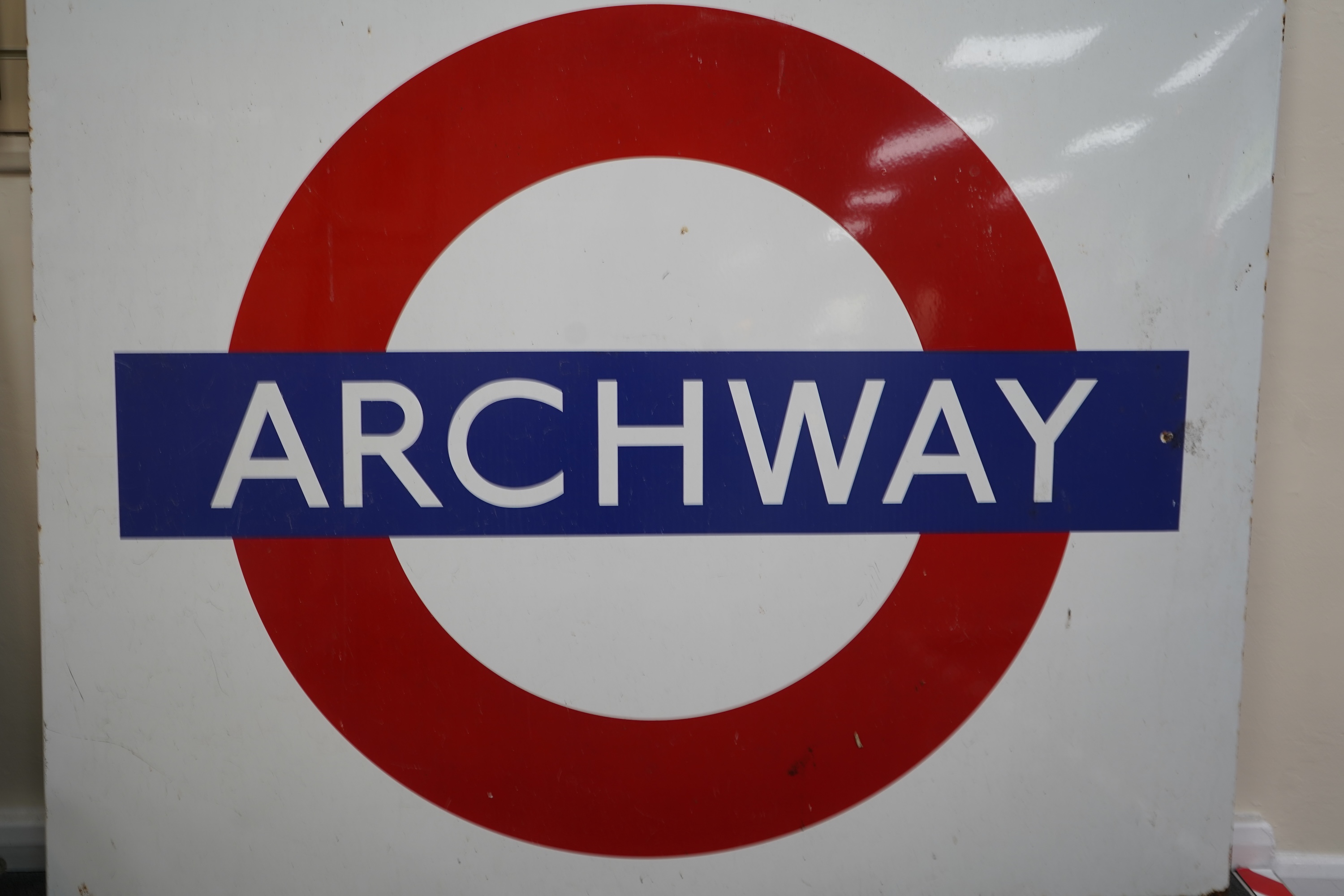 A 1950s/60s London Underground enamel bullseye station sign for Archway, 152.5cm wide, 122cm high, with plied manufacturers sticker for ‘Burnham Signs’ to the reverse